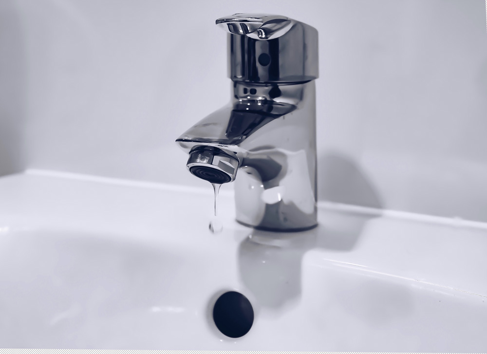 a dripping silver faucet